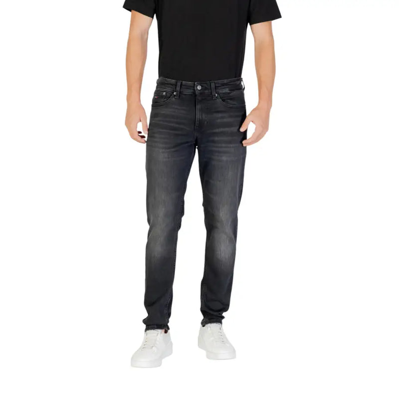 Black slim fit jeans with distressed details and white stitching.