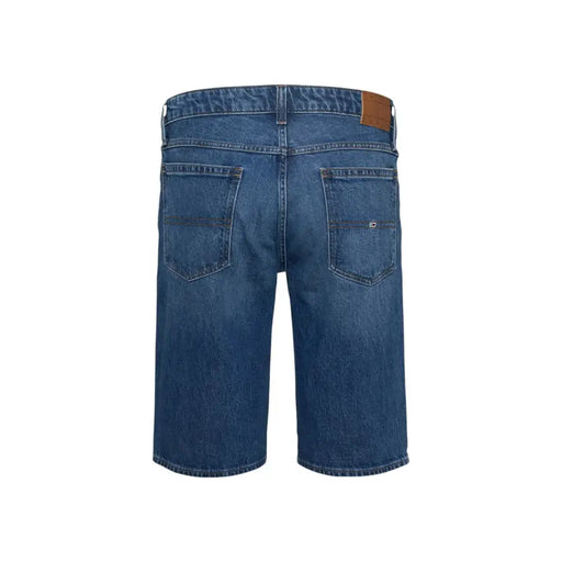Blue denim shorts with brown leather patch and buttonhole detail.