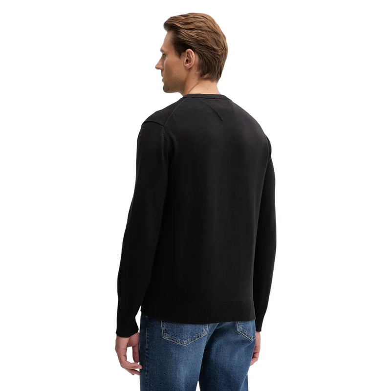 Black long-sleeved crewneck sweater with smooth knit texture made from organic cotton by Tommy Hilfiger Jeans men