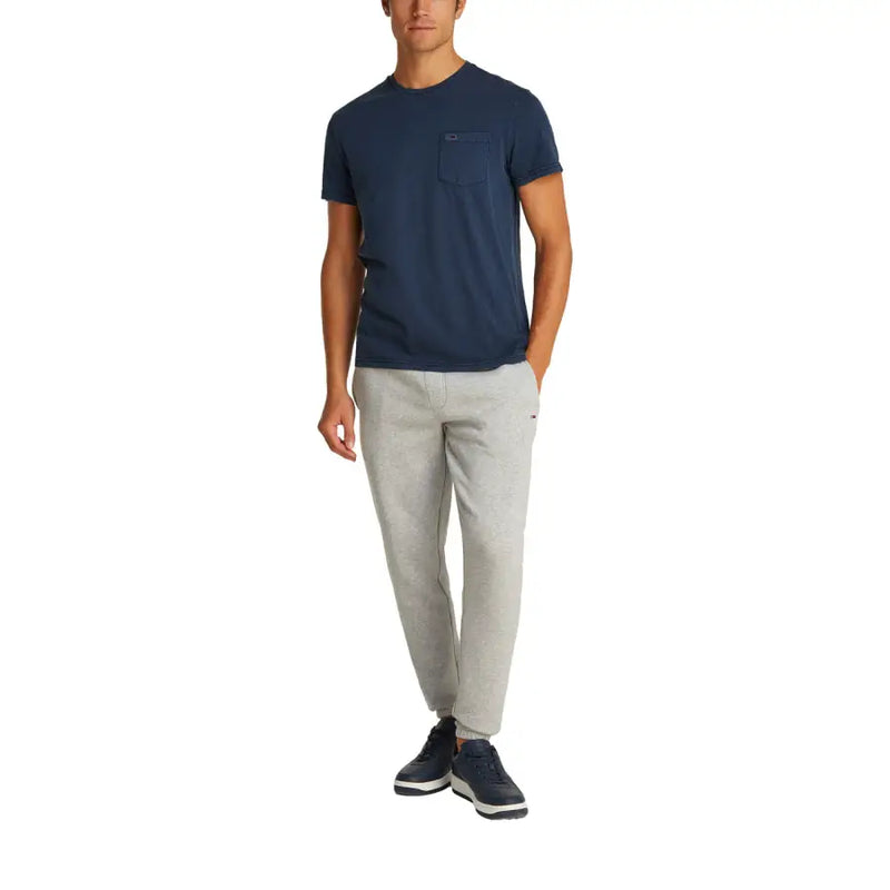 Men’s navy blue short-sleeve cotton T-shirt with chest pocket and light gray athletic pants