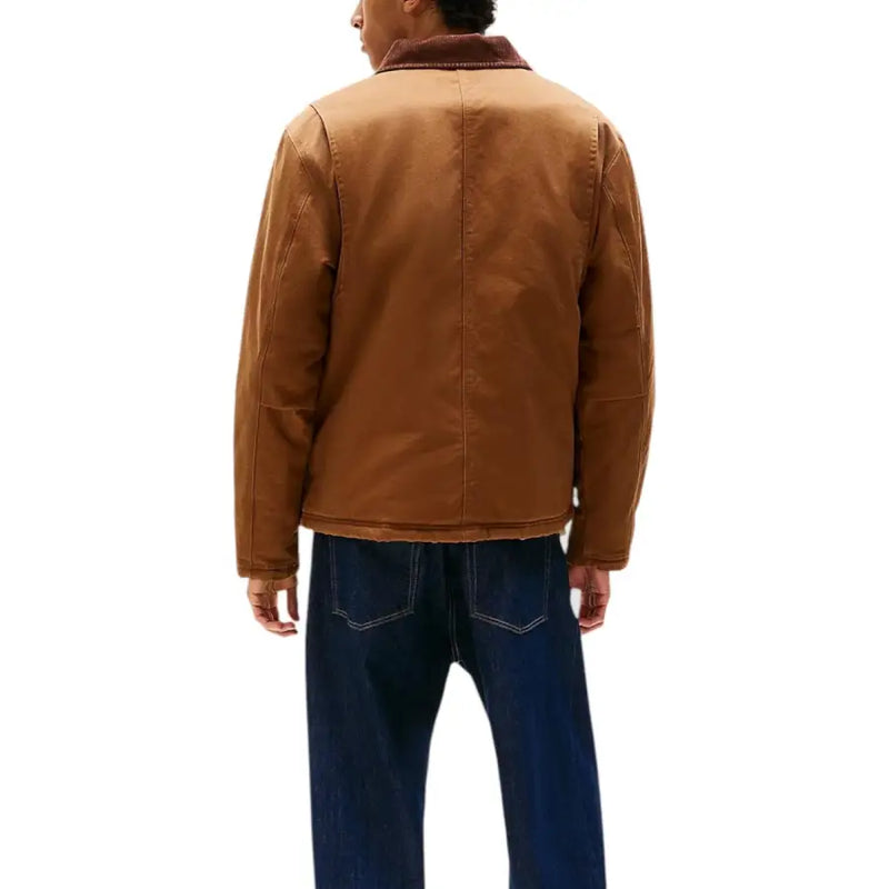 Men’s brown work jacket paired with dark blue jeans from Tommy Hilfiger Jeans collection