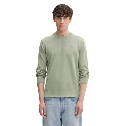 A men’s olive green organic cotton knit sweater by Tommy Hilfiger Jeans with ribbed cuffs and an embroidered logo
