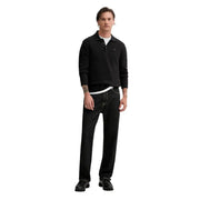 Schwarzes, langärmeliges, schmal geschnittenes Poloshirt mit kleinem, gesticktem Logo aus Bio-Baumwolle von Tommy Hilfiger Jeans
