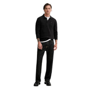 Black long-sleeved slim polo shirt with small embroidered logo made of organic cotton by Tommy Hilfiger Jeans