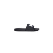 Schwarze Tommy Hilfiger Pantolette mit schwarzer Gummisohle und weißem Logostreifen über dem Riemen, Größe 2