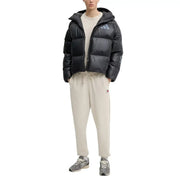 Black adidas puffer jacket with hood and quilted design shown with Tommy Hilfiger Jeans men t-shirt