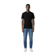Black short-sleeved crew neck cotton t-shirt with small red and white logo on lower left side by Tommy Hilfiger Jeans