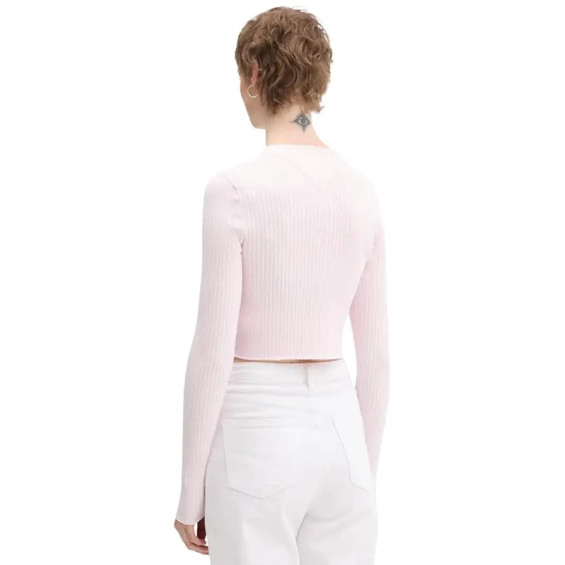 Tommy Hilfiger Jeans women pink button cardigan paired with a soft pink ribbed knit long-sleeve crop top