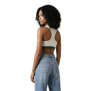 Cremefarbener Tommy Jeans Sport-BH mit schwarzem Gummiband und Logo, Teil der ärmellosen, weißen Tommy Hilfiger Damen-Jeans mit Rundhalsausschnitt top