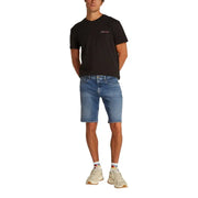 Black tommy hilfiger t-shirt with a small red white and blue logo paired with light blue organic cotton denim shorts