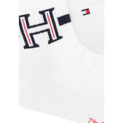 White knit sock with bold black h logo red stripes and tommy hilfiger flag emblem complementing men boxer briefs