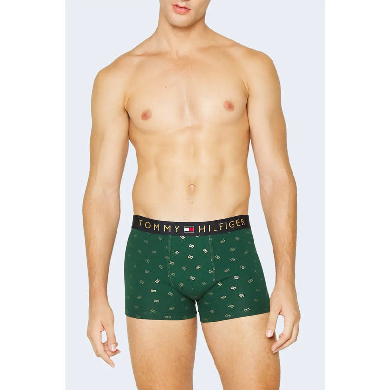 Dunkelgrüne Tommy Hilfiger Herren-Boxershorts aus Baumwolle mit weißem Logomuster und schwarzem Bund mit goldener Bio-Aufschrift