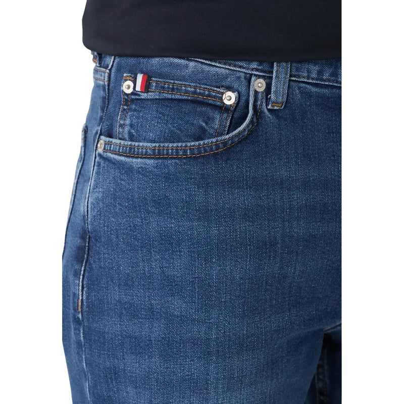 Dark blue slim fit denim jeans made of organic cotton with silver buttons and a flag patch on the back pocket