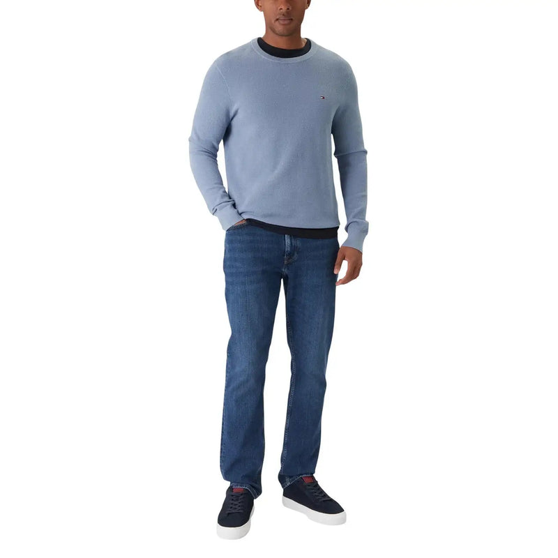 Light blue tommy hilfiger crewneck sweater with black ribbed collar paired with blue organic cotton slim fit jeans