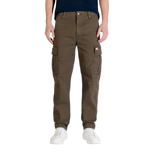 Olive green tommy hilfiger men jeans made from organic cotton featuring cargo pants with multiple pockets and logo patch