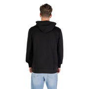 Men’s black organic cotton hooded sweatshirt with light wash blue jeans displayed for Tommy Hilfiger