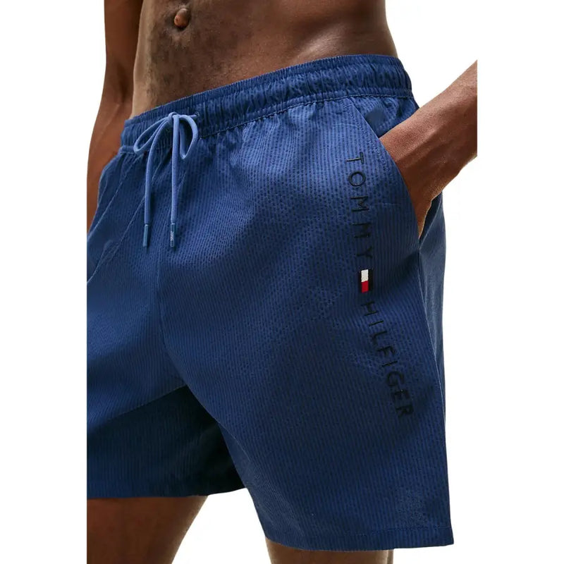 Tommy Hilfiger men swimwear blue swim trunks with textured fabric and matching drawstring for comfortable wear