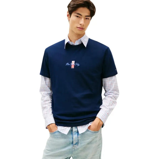 Tommy Hilfiger men navy blue short-sleeved t shirt with embroidered new york city logo made from organic cotton layered over plaid shirt