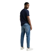 Tommy Hilfiger medium-wash blue denim jeans with classic five-pocket design and subtle fading for men