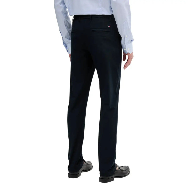 Black tommy hilfiger men tailored fit dress pants showing the back with a subtle red white and blue logo waistband