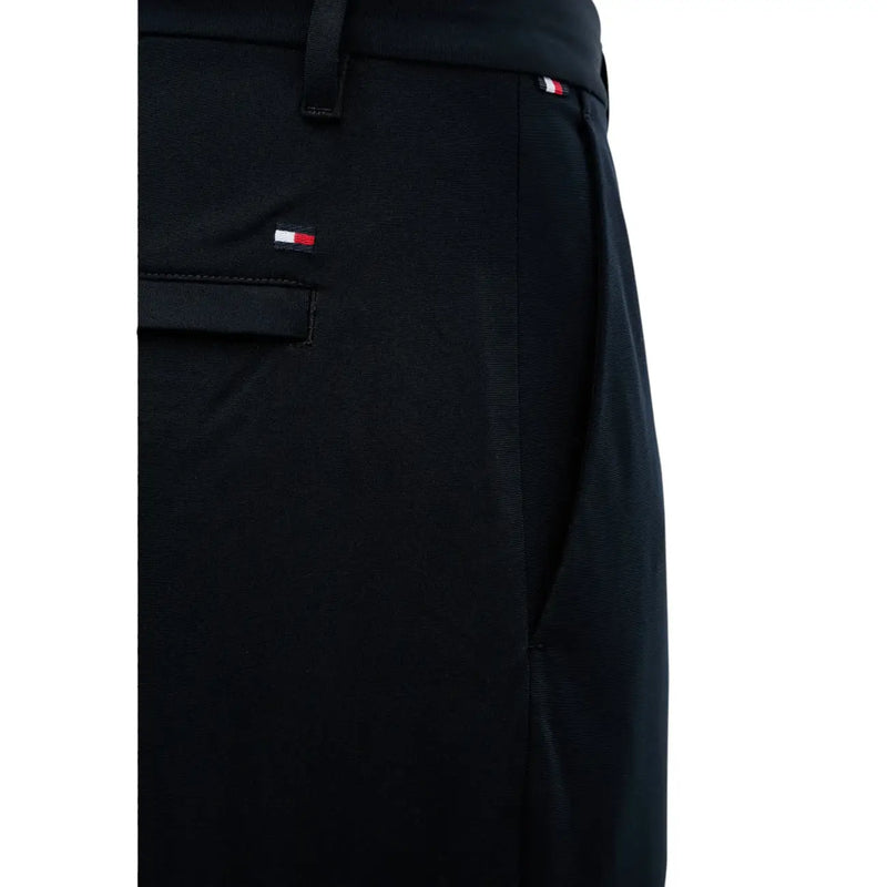 Black tommy hilfiger men trousers with subtle textured weave and signature red white and blue logo on waistband and pocket