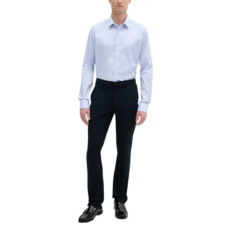 Light blue dress shirt with classic collar and button-down front paired with tommy hilfiger men trousers