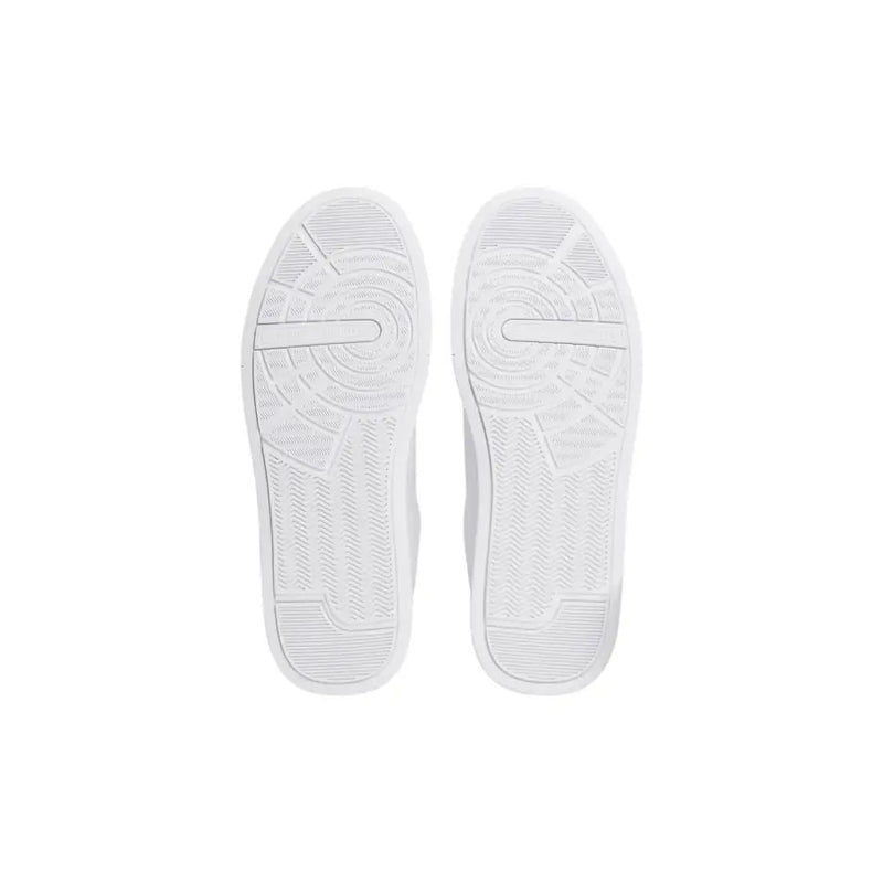 Weiße Gummisohlen mit strukturiertem, kreisförmigem Profil und dezenten geometrischen Linien auf weißen Tommy Hilfiger Herren-Sneakers aus Leder.