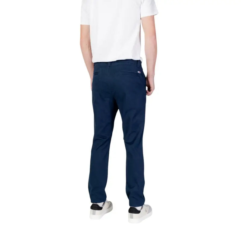 Back side view of tommy hilfiger men’s navy blue chino pants with subtle woven texture and brand logo on pocket