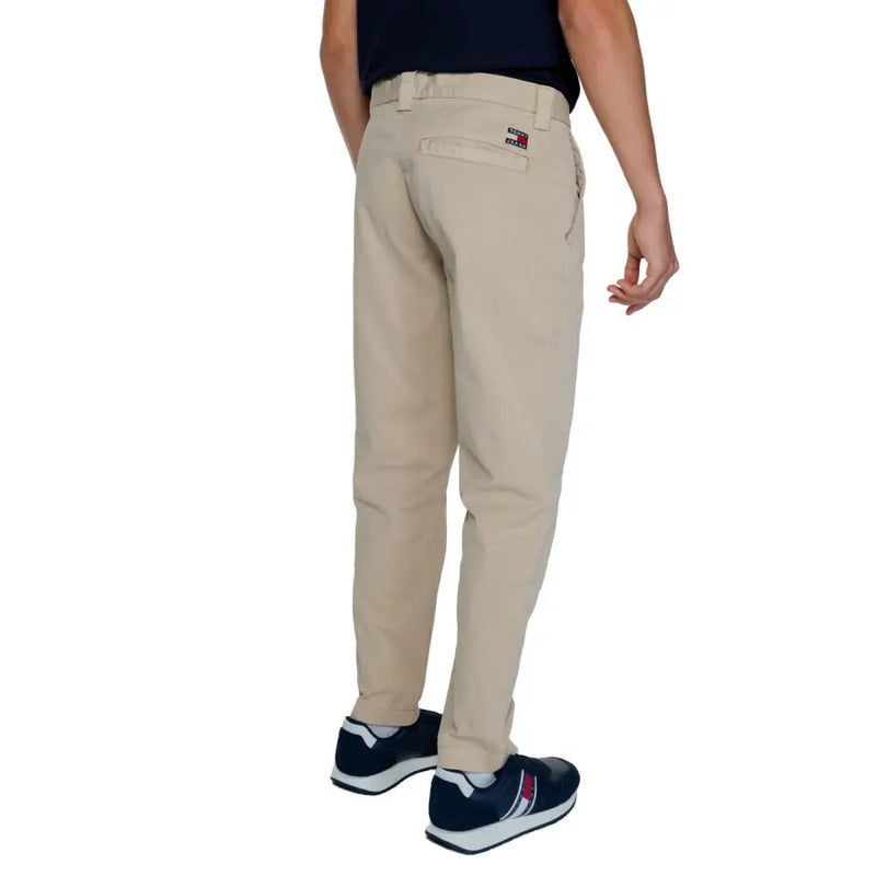 Men’s beige chino pants with small flag logo on back pocket from Tommy Hilfiger Fall Winter collection