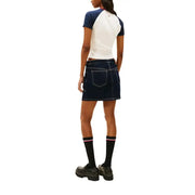 Dark blue denim mini skirt with white stitching and back pockets shown with tommy hilfiger white printed organic cotton t-shirt for women