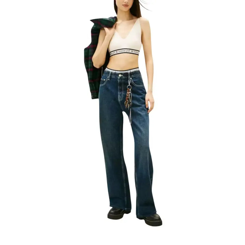 Tommy Hilfiger white sleeveless v neck knit top paired with high-waisted dark blue straight-leg denim jeans with keychain