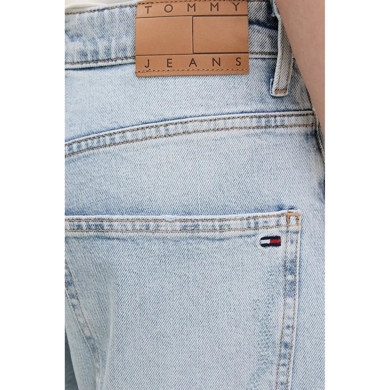 Back side of tommy hilfiger women’s light blue ripped jeans in light-wash denim with tan leather label and flag logo