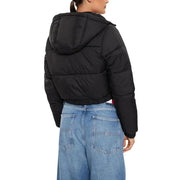 Black hooded puffer jacket with turtleneck paired with light-wash wide-leg jeans