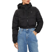 Woman wearing Tommy Hilfiger black nylon hooded puffer jacket with turtleneck and light blue jeans