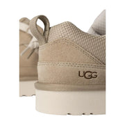 Beige ugg women suede lace up sneaker with suede and mesh upper featuring pull tab and embossed logo on the heel back side