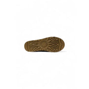 Brown rubber sole with distinctive starburst tread and ugg logo embossed near the heel on ugg women beige suede slippers