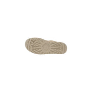 Beige ugg women leather boots spring footwear showing the back side with starburst tread rubber sole and ugg logo embossed