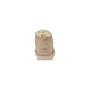 Beige suede ugg women leather boot with plush white lining and classic logo patch ideal for spring footwear