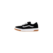 Black and white vans skate shoe with suede upper, rubber sole, classic low-top design.