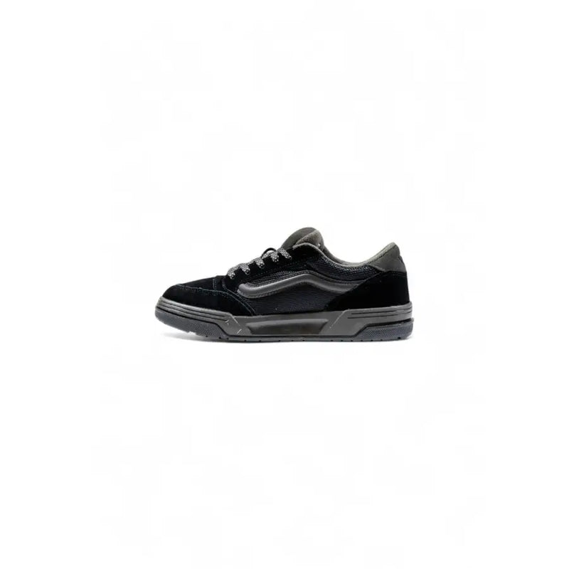 Black and white low-top sneakers with a glossy patent leather upper, vans old skool model.