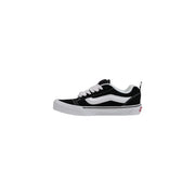 Back side of black and white vans old skool skate shoe with canvas upper rubber sole and red logo on heel for women