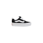 Vans women leather sneakers in black with thick rubber soles and classic old skool platform design in black and white