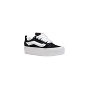 Black vans women leather sneakers featuring white laces, a signature side stripe, and thick white rubber soles
