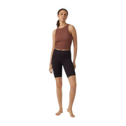 A woman wears vero moda women black nylon slip on biker shorts paired with a rust sleeveless crop top