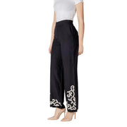 Black wide-leg Vila Clothes trousers in cotton linen viscose with elegant white embroidered floral patterns on lower legs