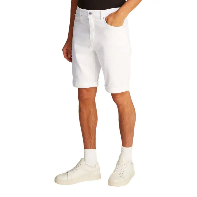 Men’s white denim shorts displayed alongside a black tank top in a casual outfit display