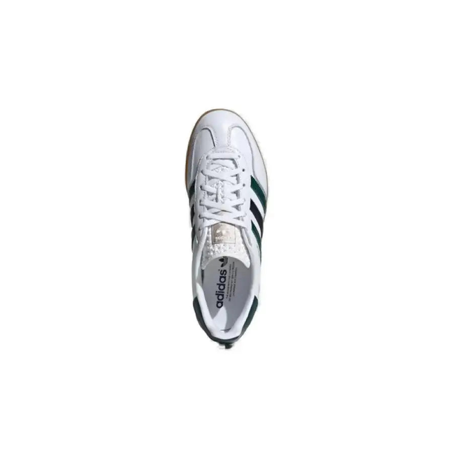 
                      
                        White and green Adidas sneakers for men, showcasing urban city style fashion
                      
                    