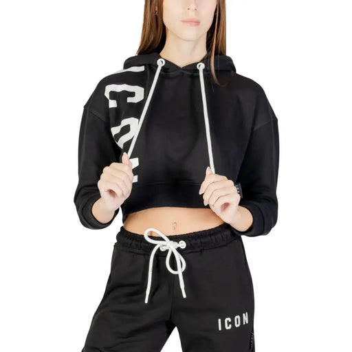 Schwarzer, kurzer Hoodie mit weißen Kordelzügen und auffälligem Ärmelaufdruck auf weißem Damen-Sweatshirt aus Baumwollmischgewebe.