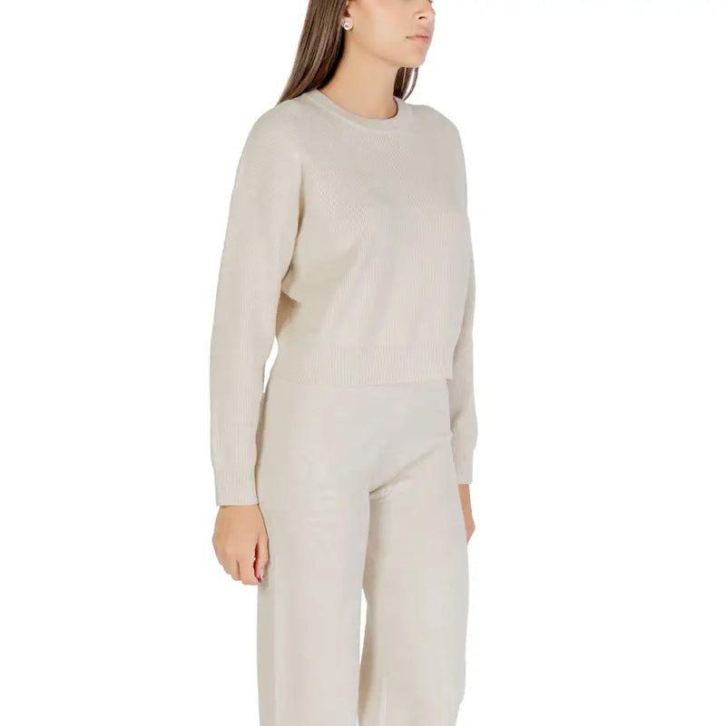 Cream-colored ribbed knit sweater for women with long sleeves and a round crew neckline