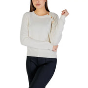Cream-colored long sleeve round neck knit top for women featuring wooden buttons along the shoulder seam